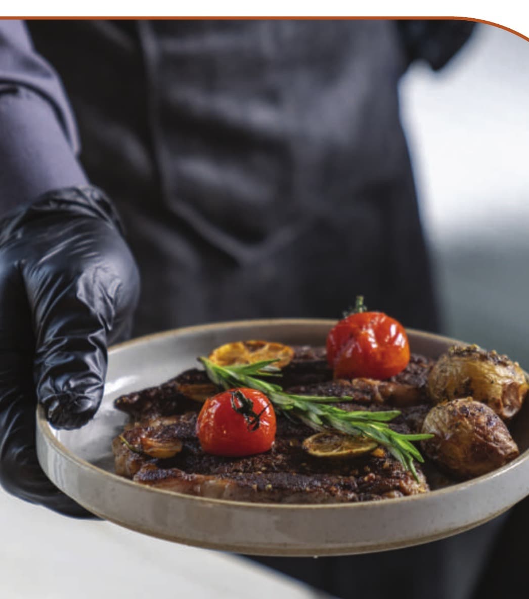 A grilled steak plate at the pass