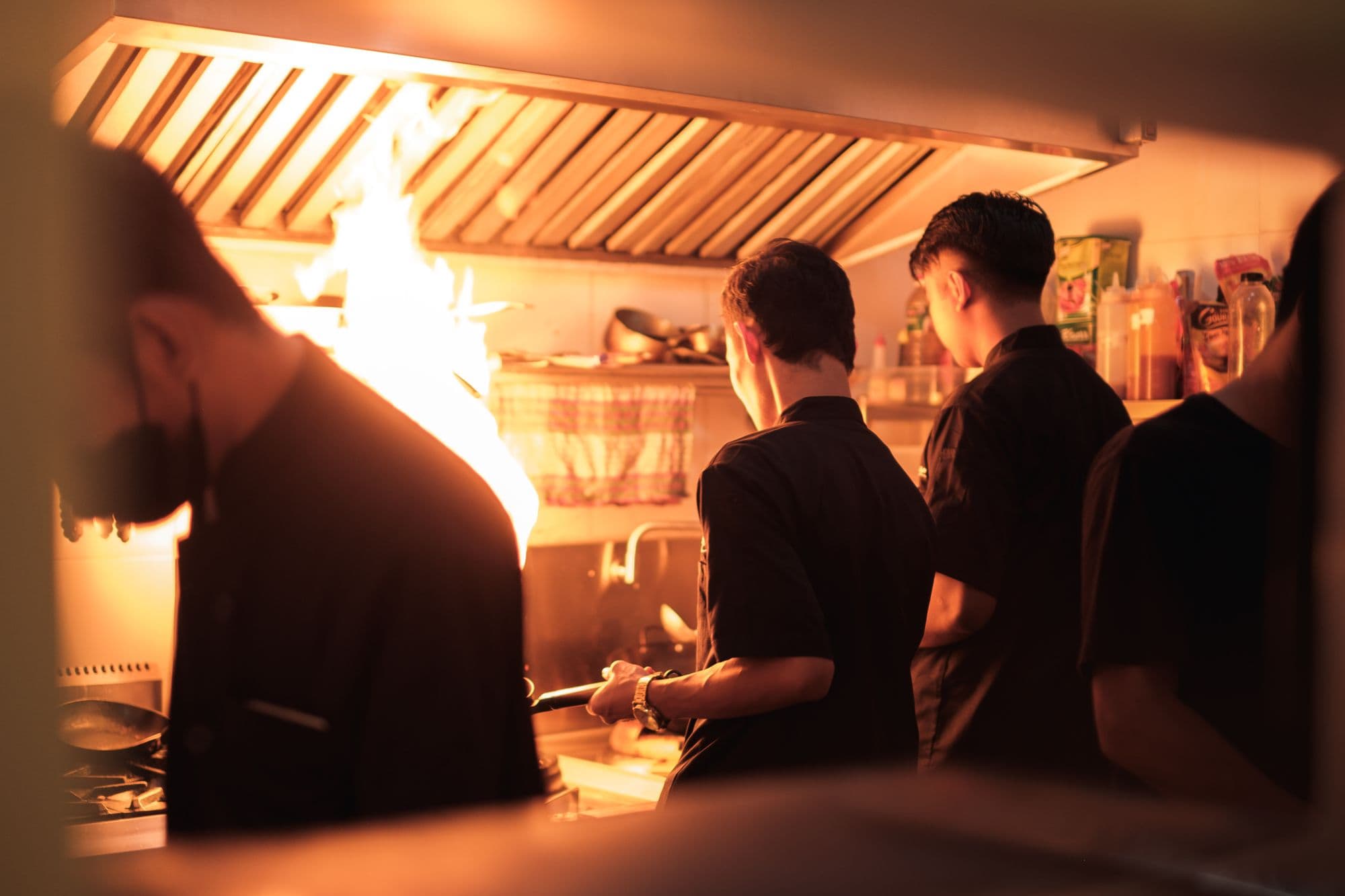 Chefs working the line in a professional kitchen