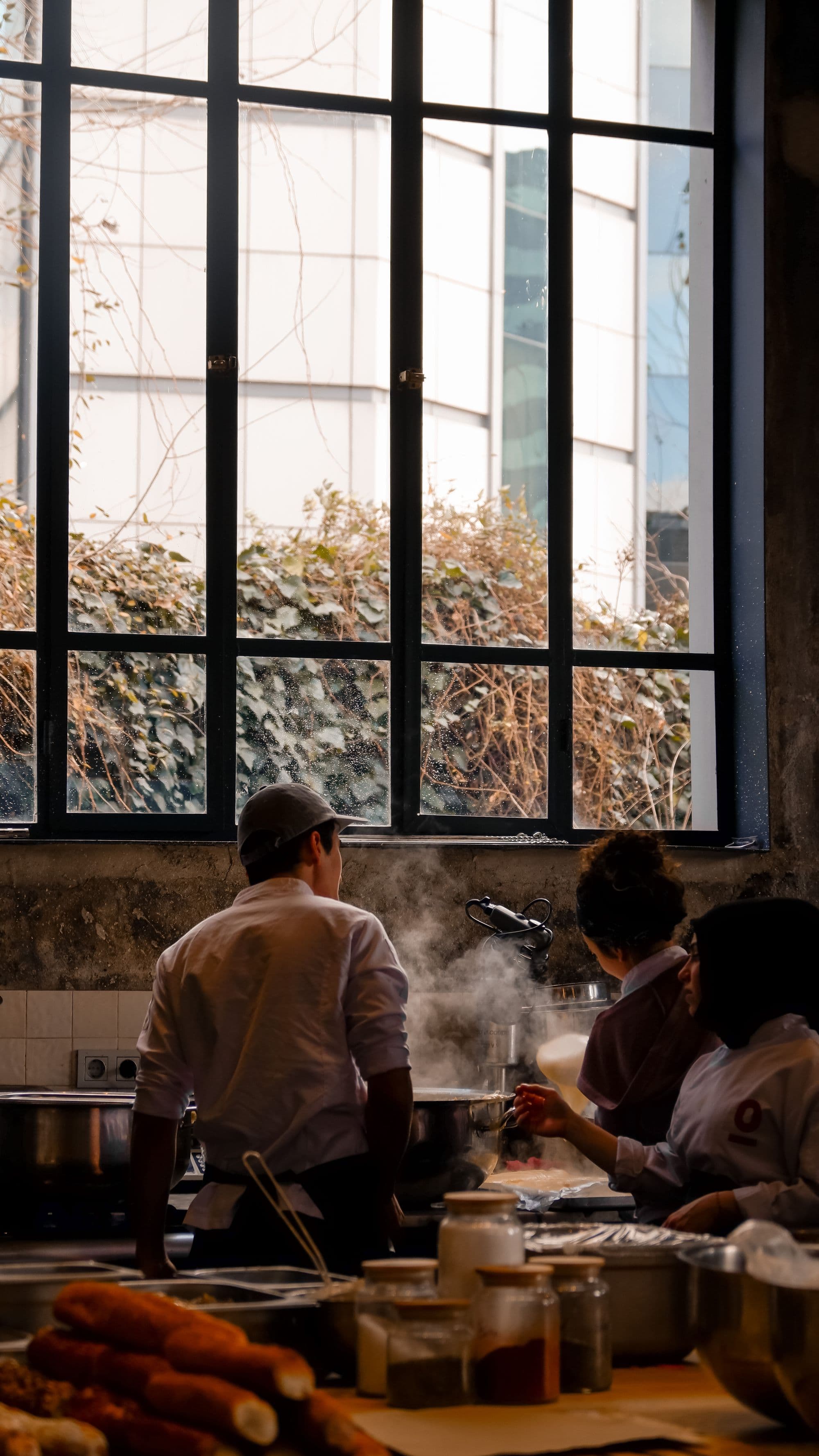The ISFC kitchen team gathered by the window of a professional kitchen