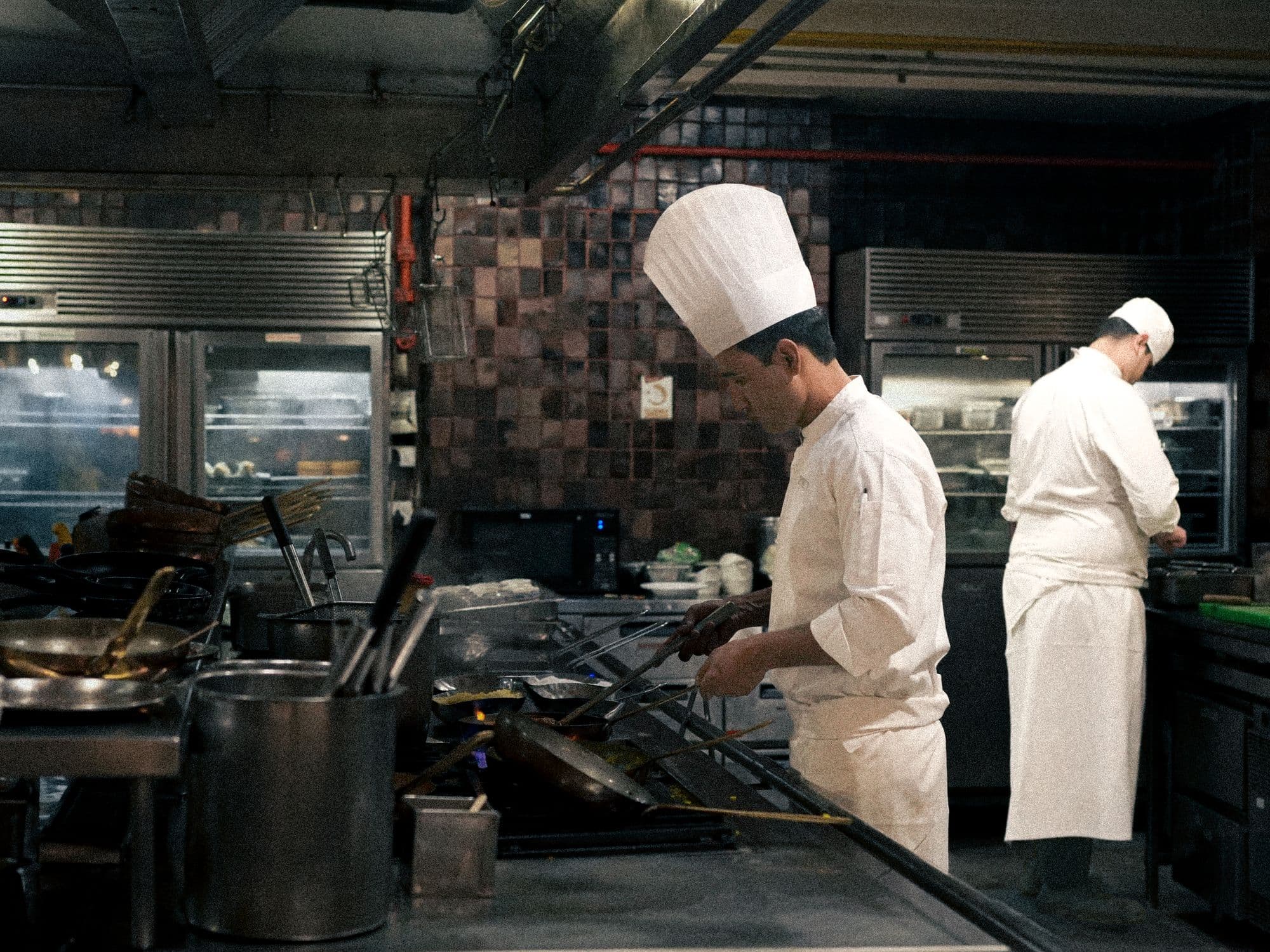 Chefs working the line in a professional kitchen